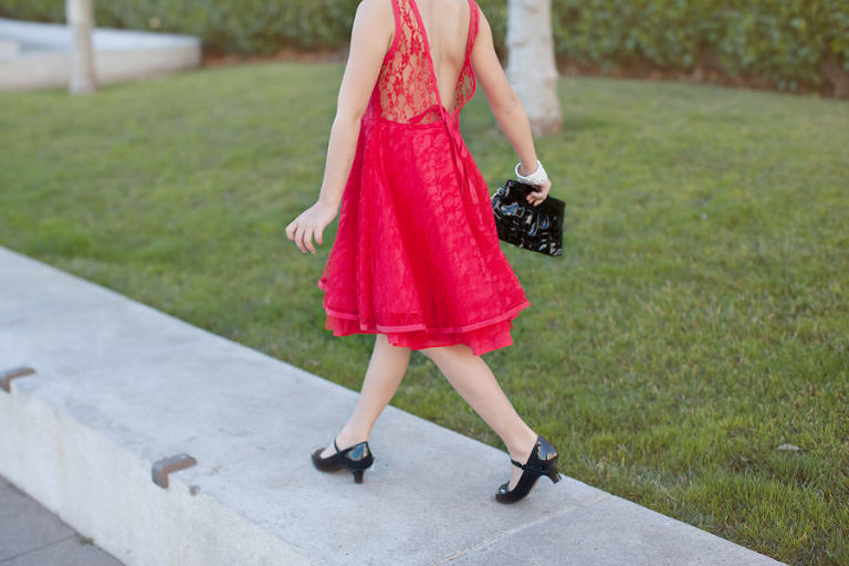 portrait of little girl walking in red dress in san francisco