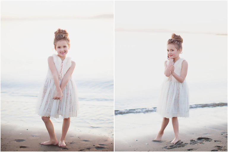 little girl in white dress posing for pictures on the sandy beach in alameda