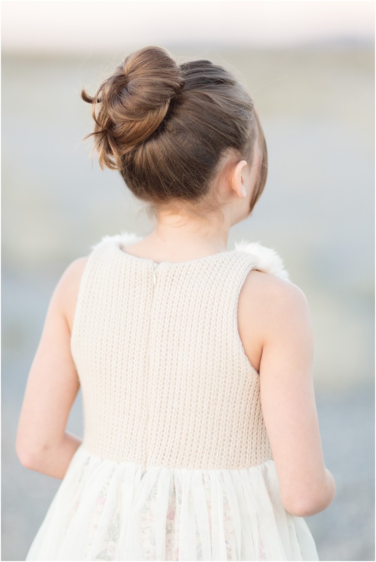 back of child showing back of dress and hair in a top knot -livermore photographer