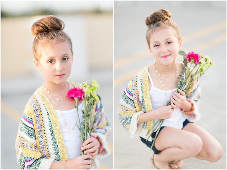 gorgeous little girl with top knot and boho chic style holding flowers