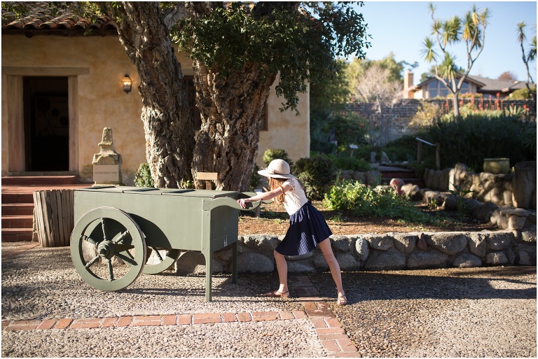 Little girl pushing a cart in the modern courtyard at mission carmel
