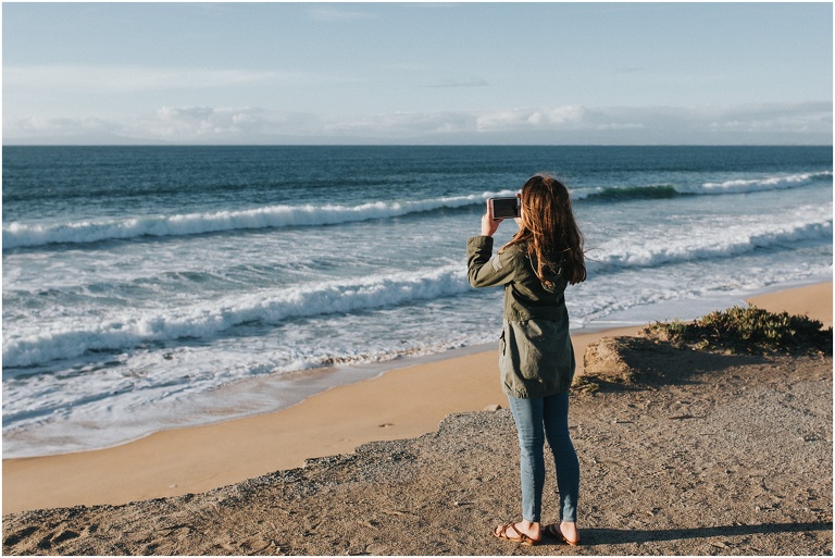 Little girl photographing the Pacific Ocean in Carmel California