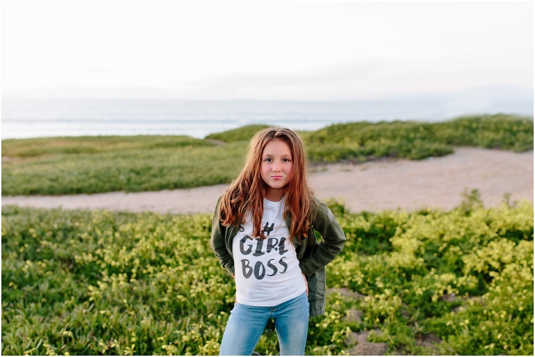 girl wearing a girl boss shirt on the beach in Carmel