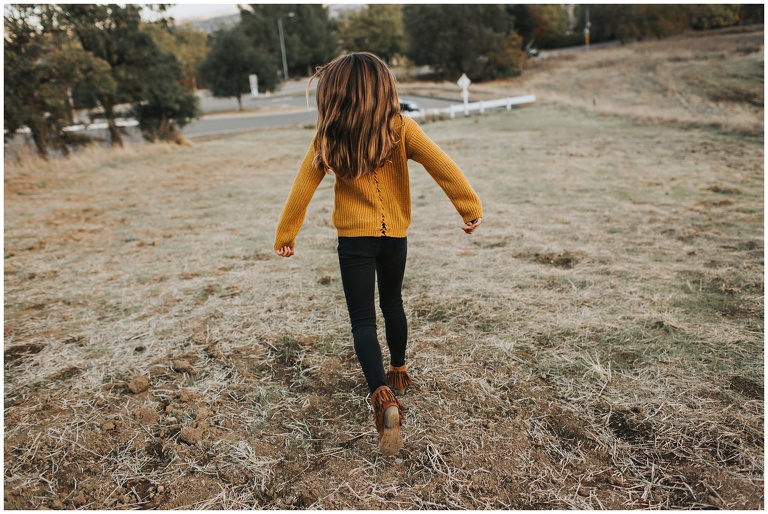 little girl running down the hill at alviso adobe park 