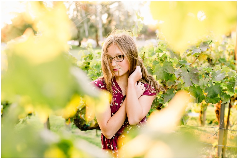 headshot of teen in maroon dress in vineyards
