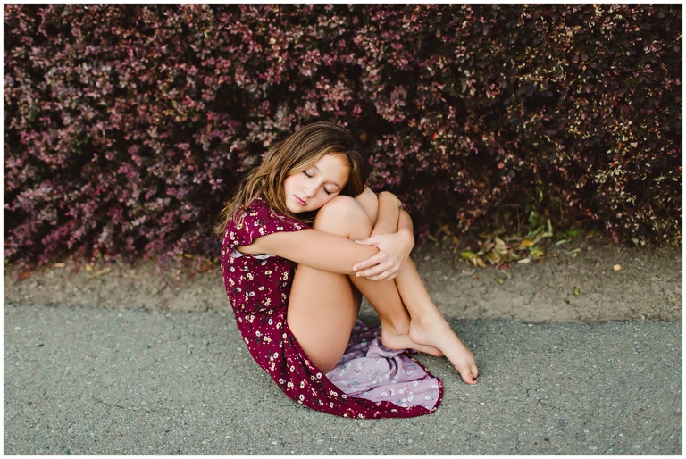 child hugging knees close wearing Target dress